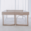 A Mummio Portable Safe Space dune baby playpen with a white mesh canopy and a small attached arch play door, set up on a light-colored floor in front of white sheer curtains. The brand name 'Mummio' is printed on the side.